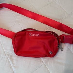 Red lululemon belt bag with name